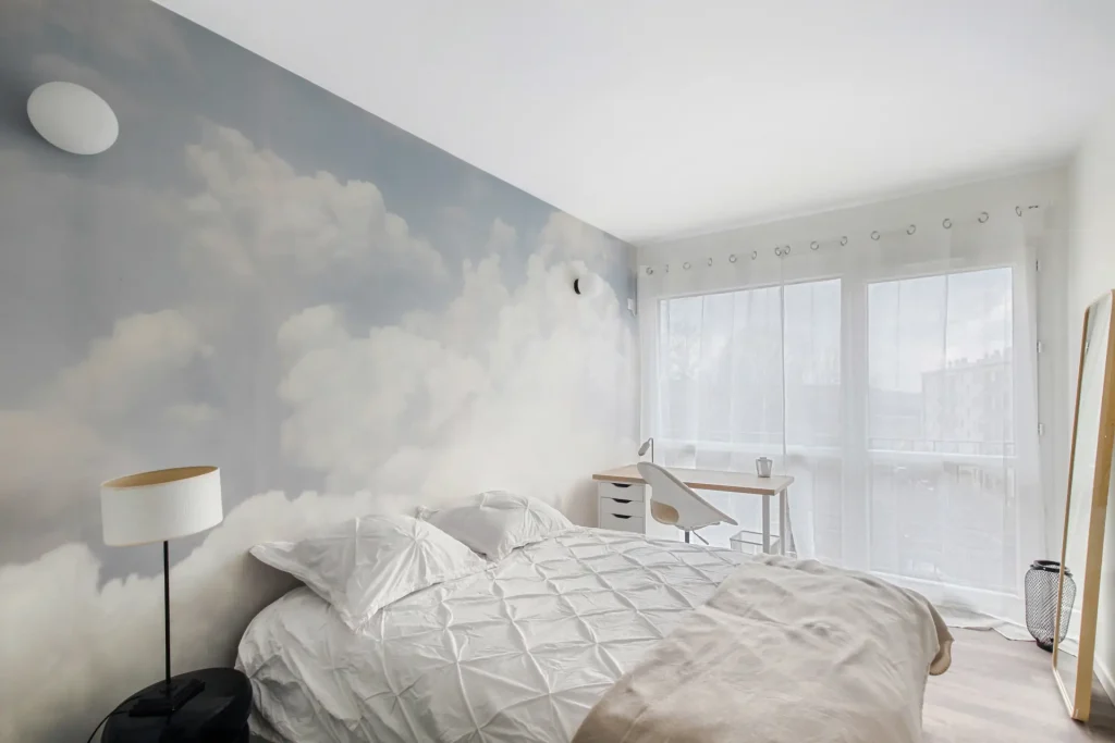 Chambre avec papier peint nuages et décoration sobre